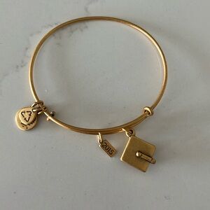 Alex and Ani gold graduation cap bracelet.